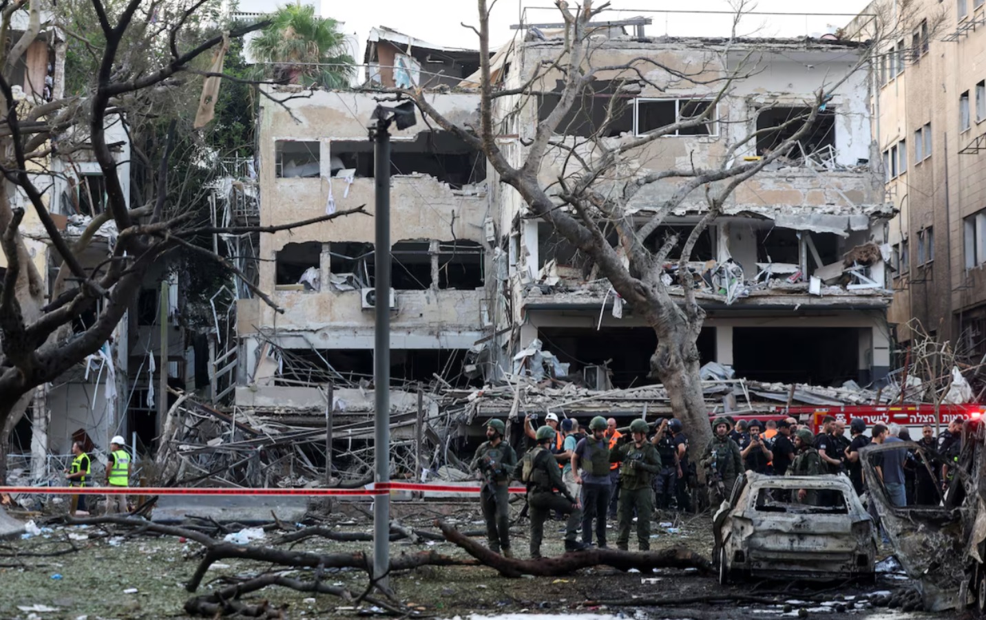 伊朗向以色列发射导弹后，应急人员在以色列特拉维夫的撞击现场工作