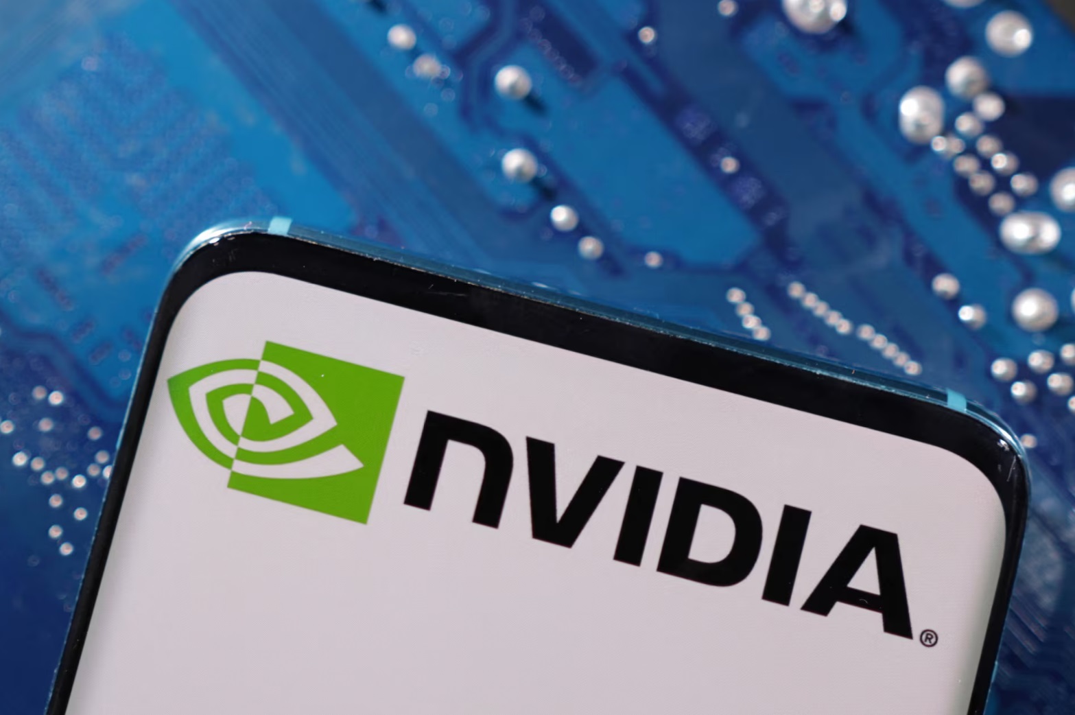 一部带有 NVIDIA 徽标的智能手机被放置在计算机主板上